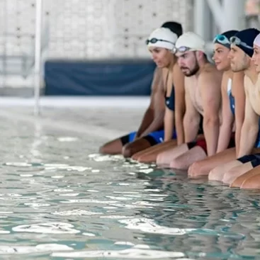 Adult participating in a swim lesson at Marina Swim School, focusing on stroke techniques and water confidence