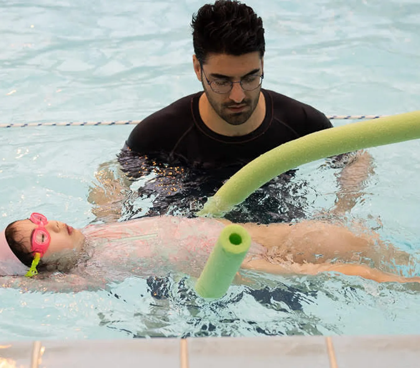 Marina’s Swim School instructor teaching a swimmer the whip kick technique used in breaststroke.