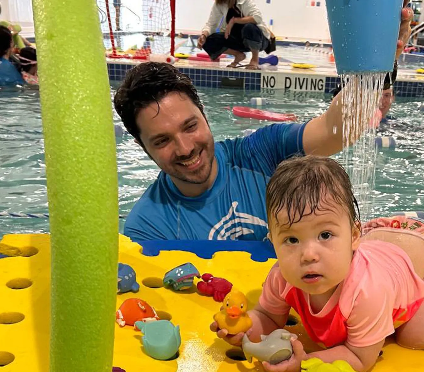 Parent and toddler participating in a swim class at Marina’s Swim School, building water confidence and early swim skills together.