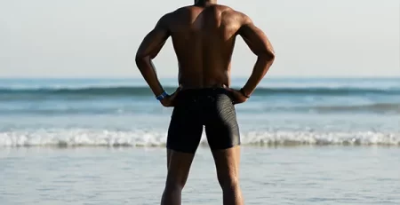 Adult swimmer standing at the shoreline preparing for open water swim training at Marina’s Swim School.