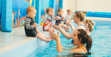 Marina’s Swim School baby and infant swim class with parents and instructors teaching water confidence and safety.