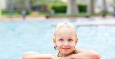 Portrait of happy little girl in swimming pool