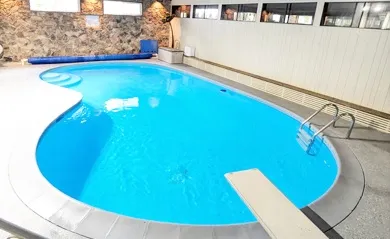 Marina’s Swim School Surrey and Delta location with heated indoor pool and diving board, ideal for swim lessons for all ages.
