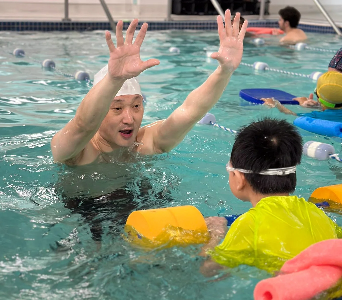 Marina’s Swim School instructor encouraging a young swimmer to overcome fear and build confidence in the water.