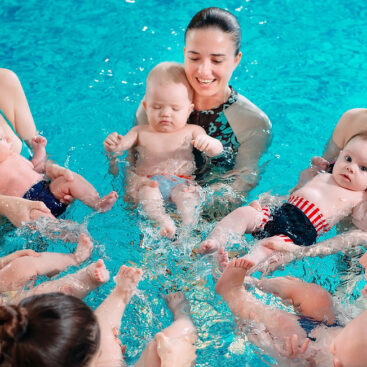 Parent and baby participating in infant swim class at Marina Swim School with instructor guidance